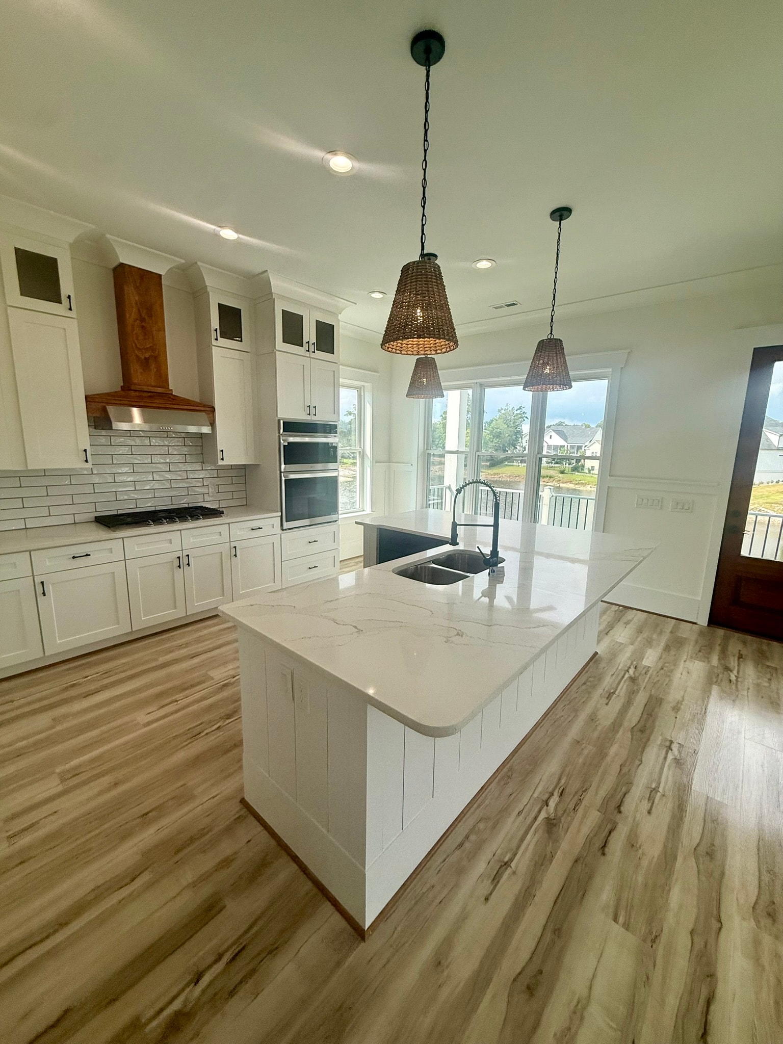 Bright kitchen with island and pendant lights